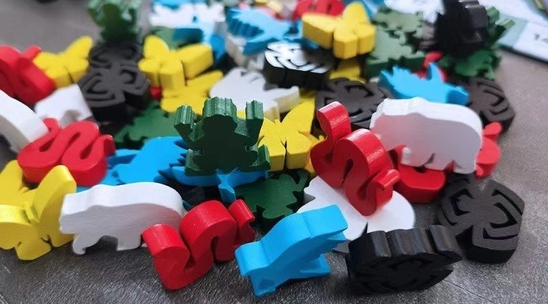 Colorful custom wooden tokens and meeples for board games